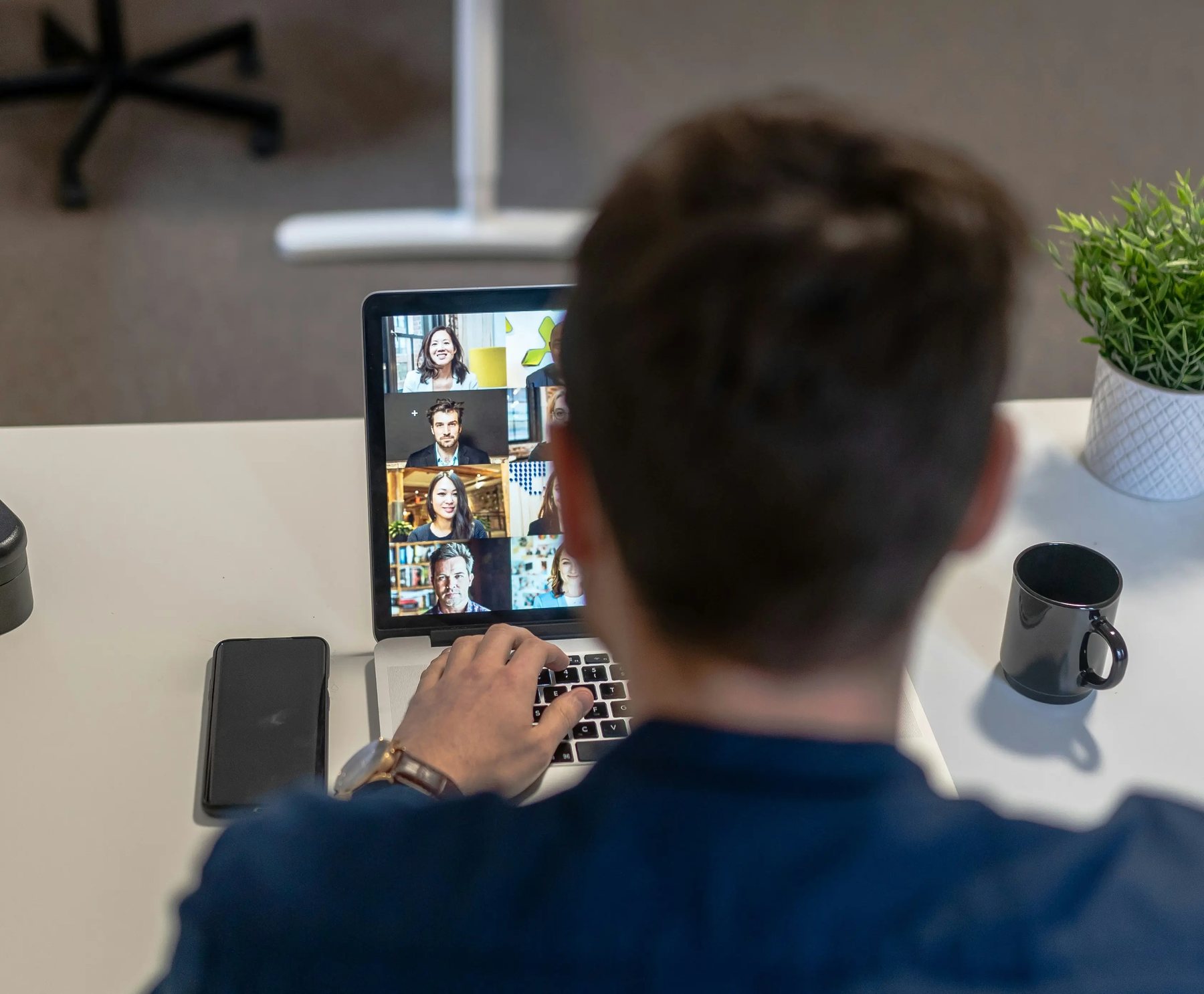 Over the shoulder shot of a project team member attending a virtual advisory committee meeting